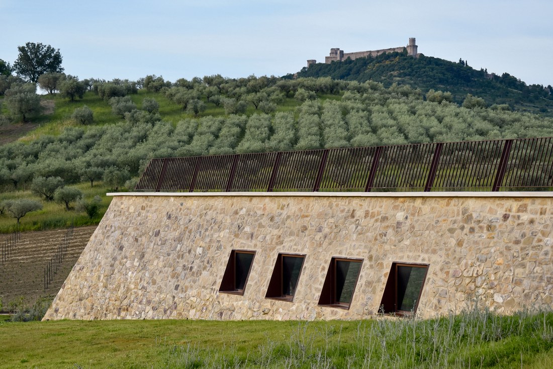 Inclined stone wall with angled openings below the Rocca Maggiore